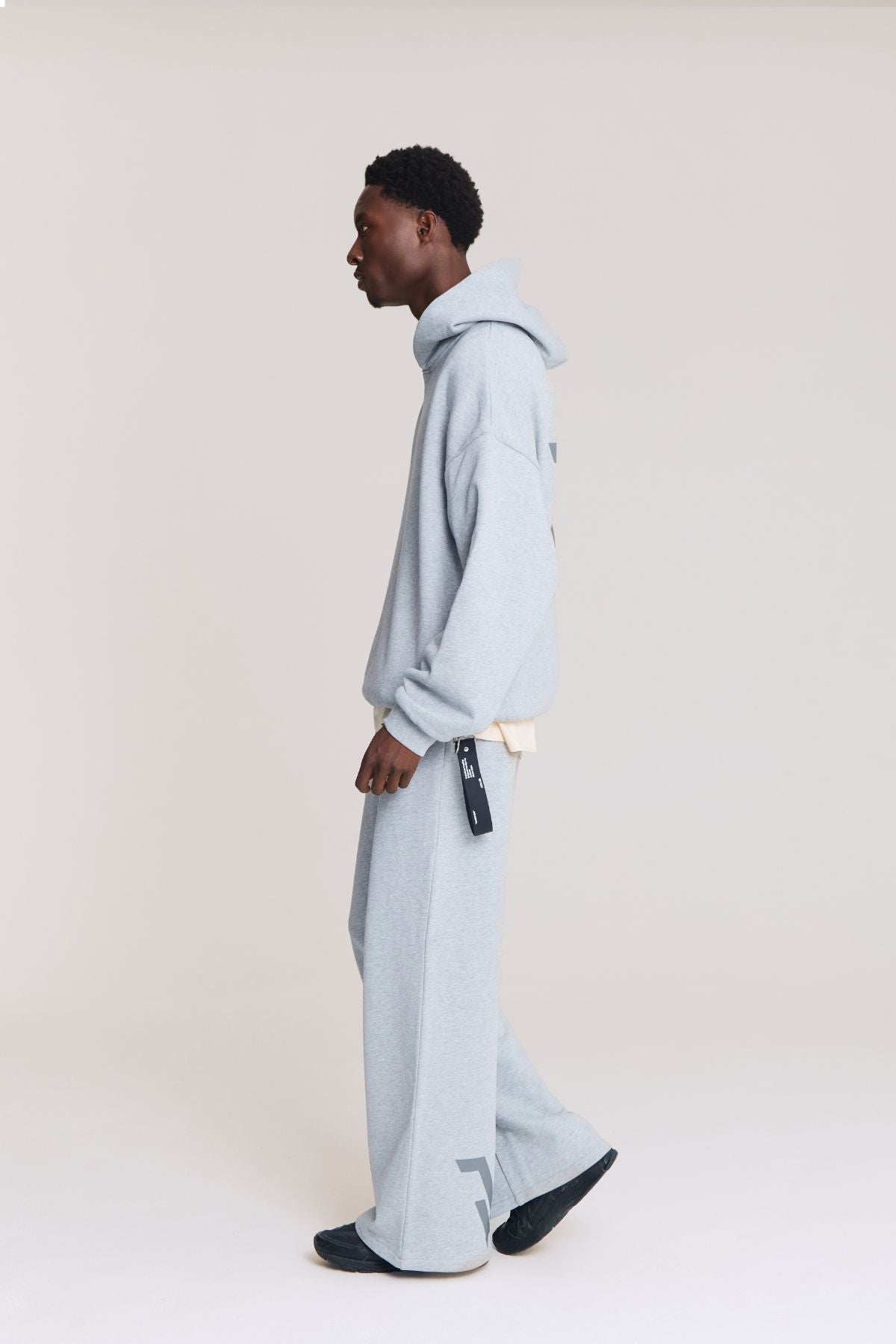 Man wearing the grey hoodie