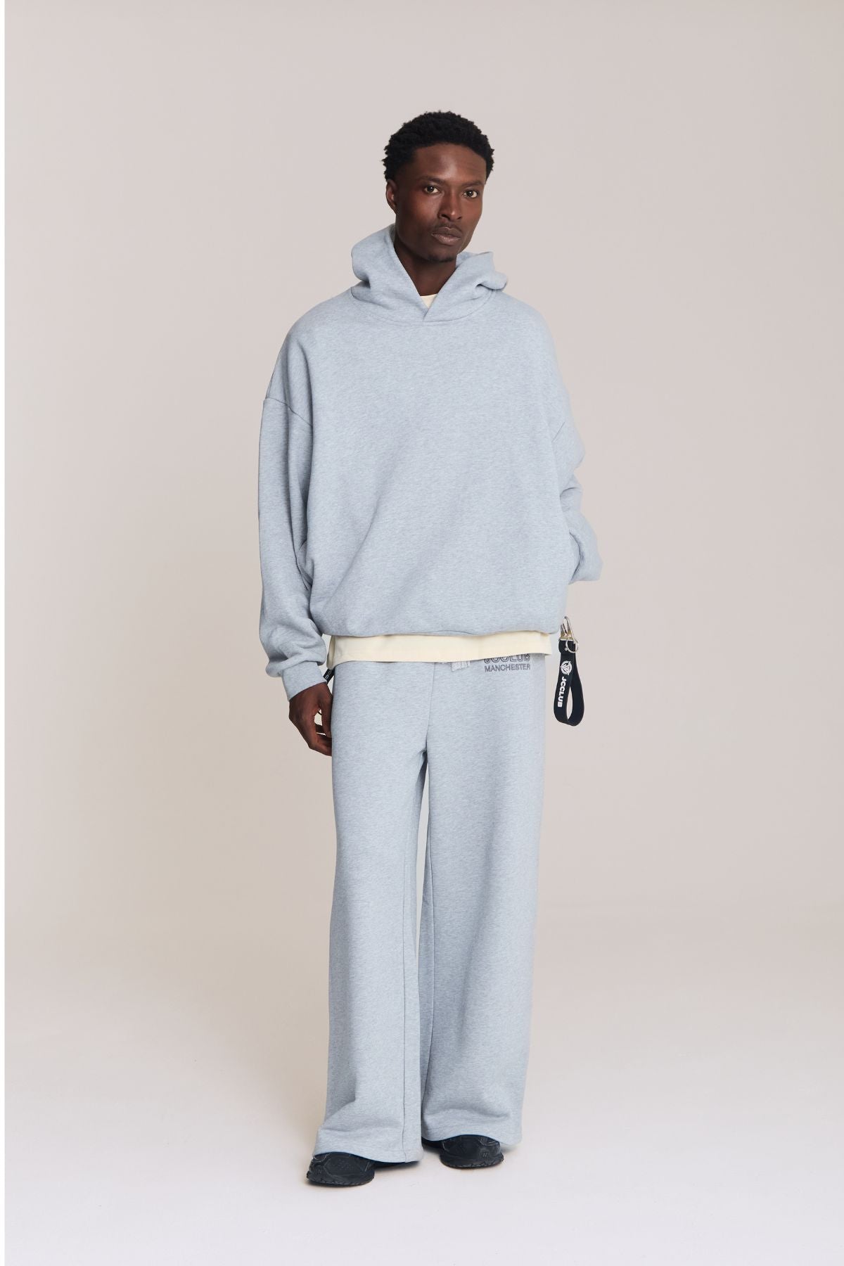 Man wearing the grey hoodie