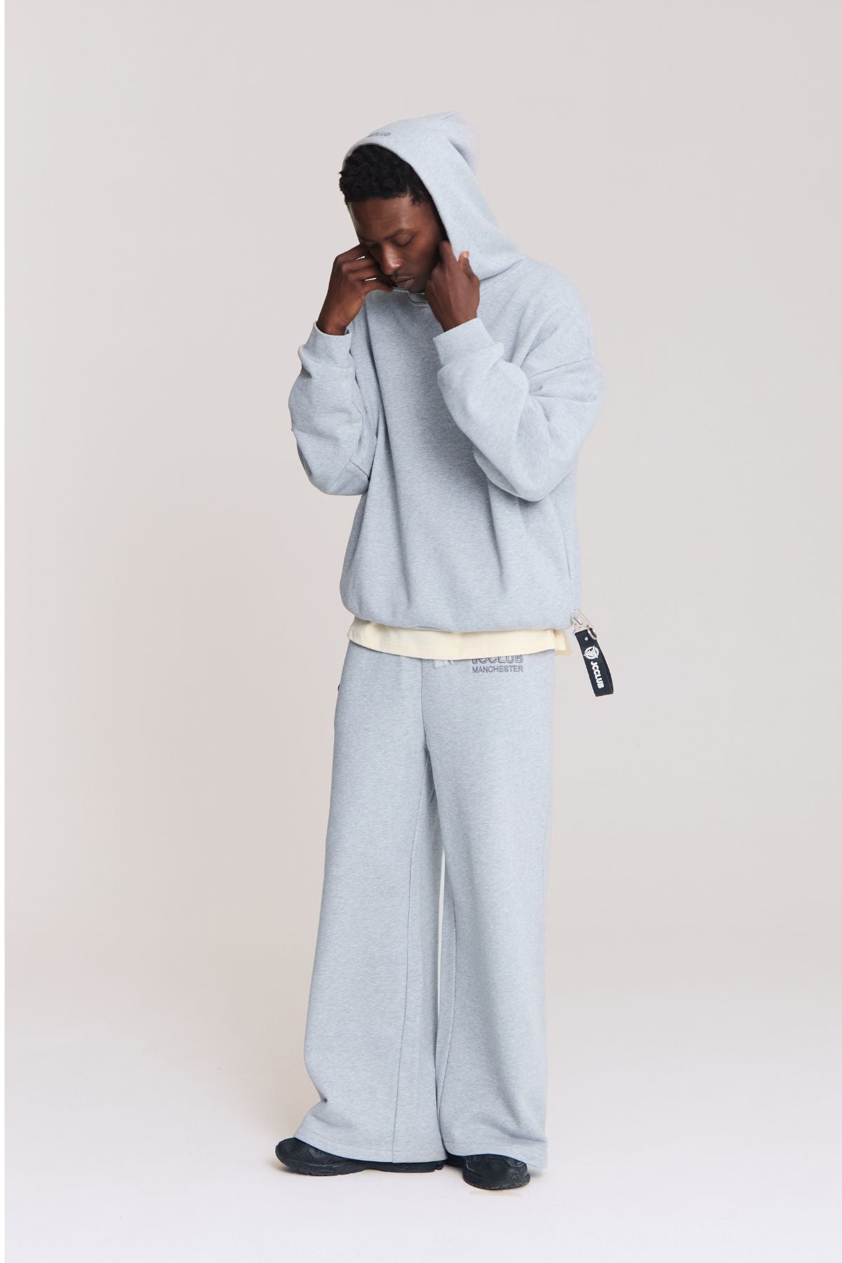 Man wearing the grey hoodie