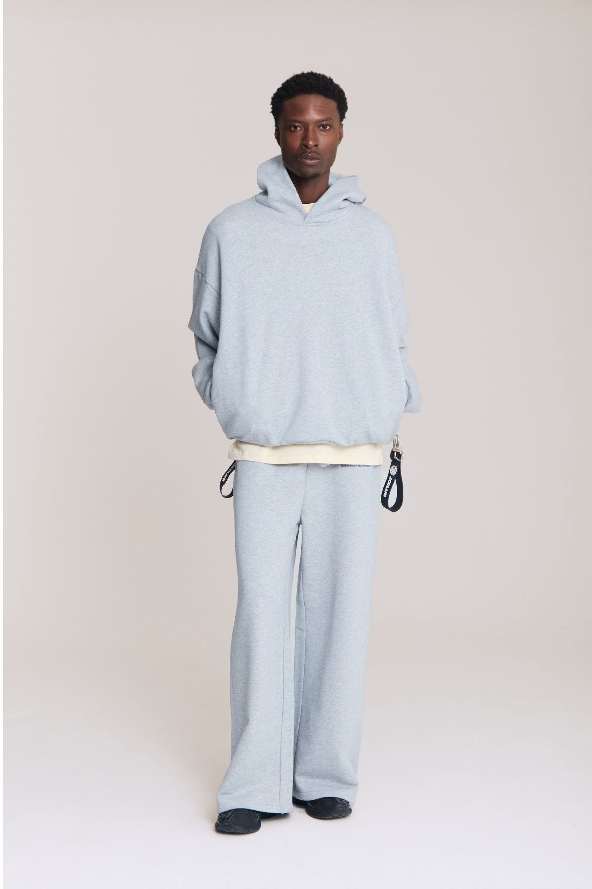 Man wearing the grey hoodie