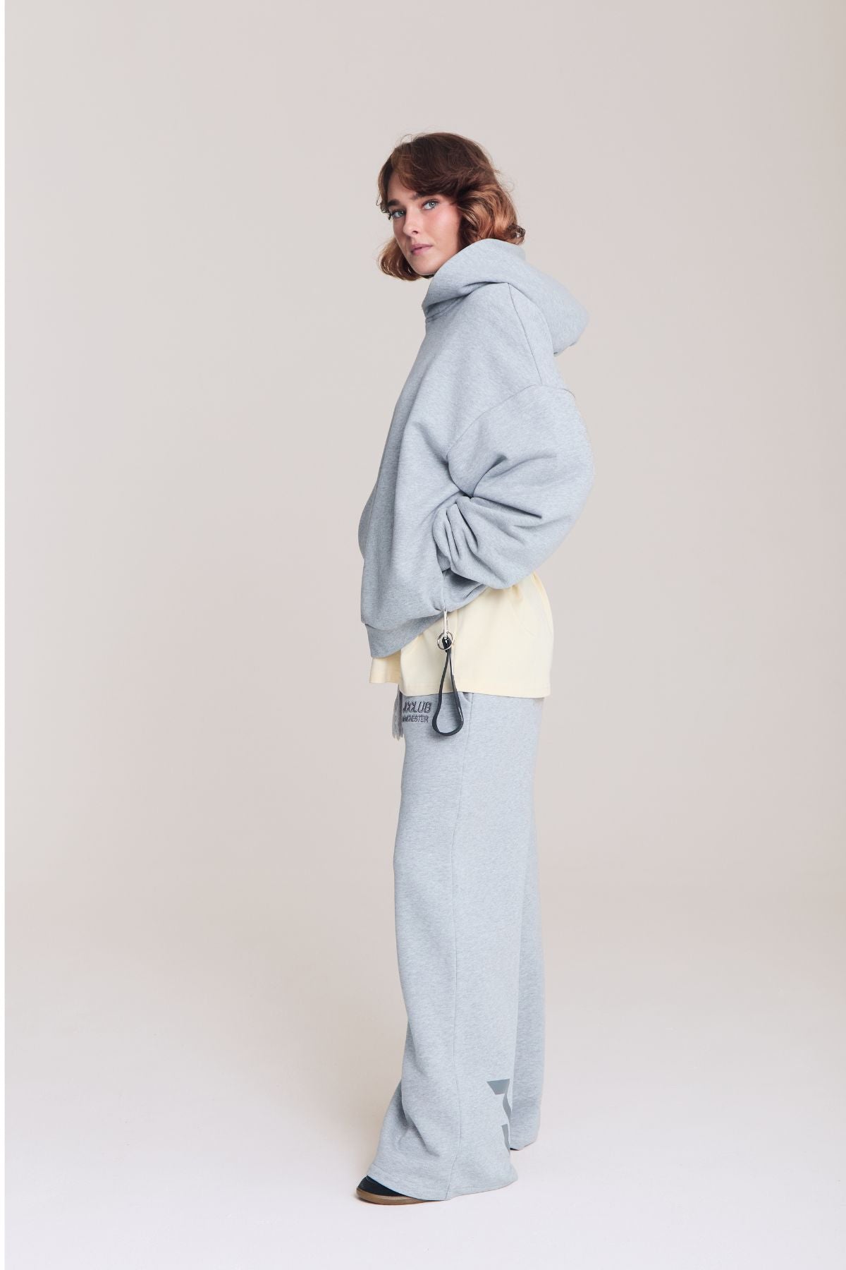 Woman wearing the grey hoodie
