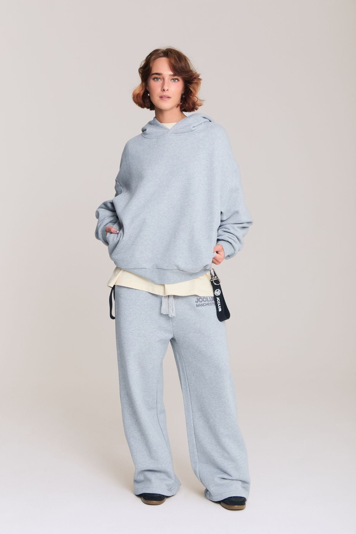 Woman wearing the grey hoodie