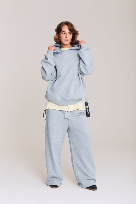 Woman wearing the grey hoodie
