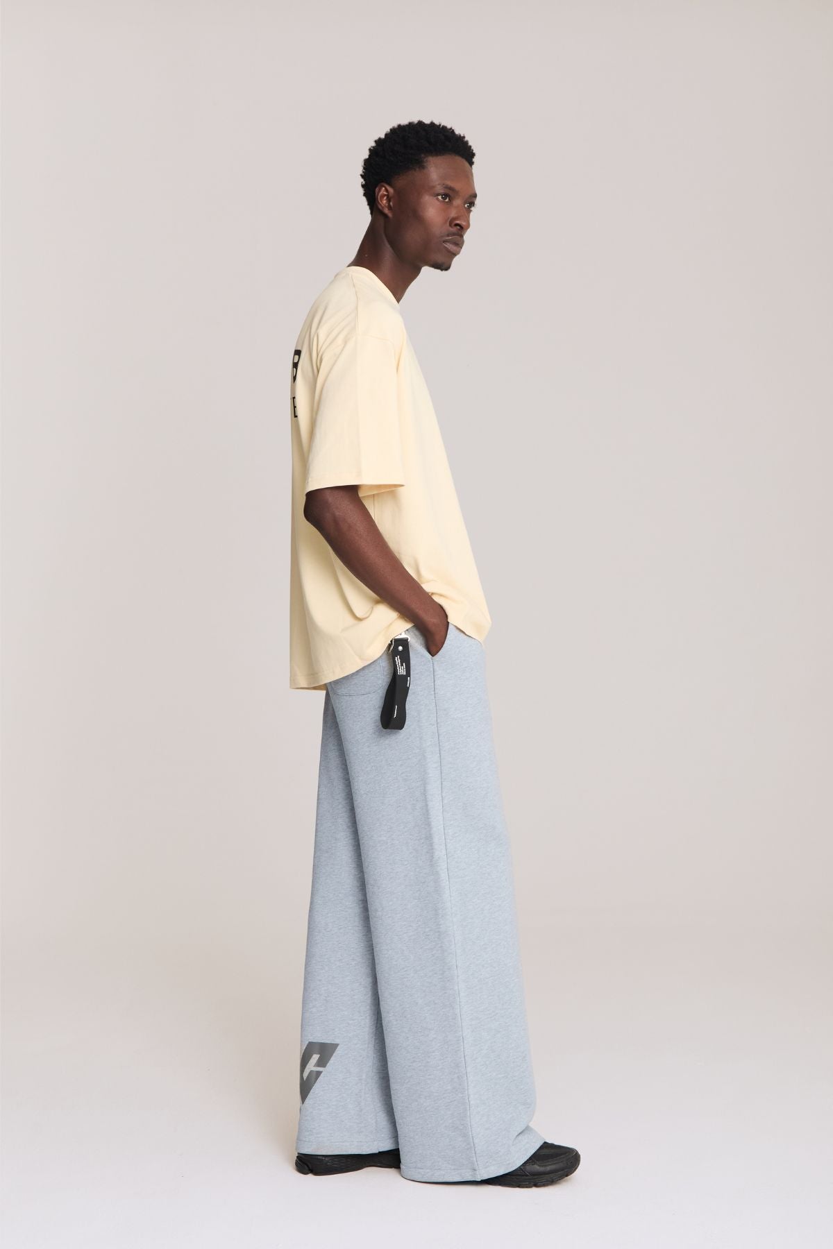 Man wearing the beige shirt