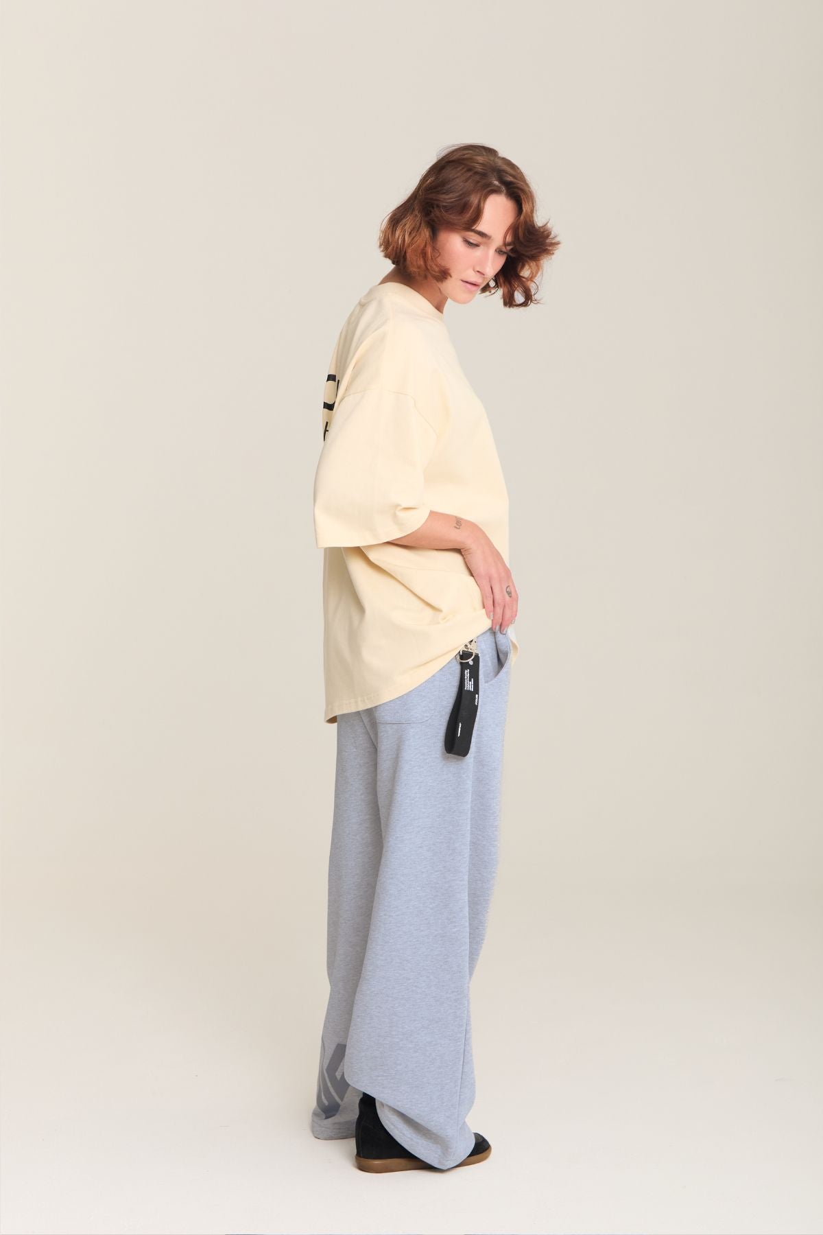 Woman wearing the beige shirt