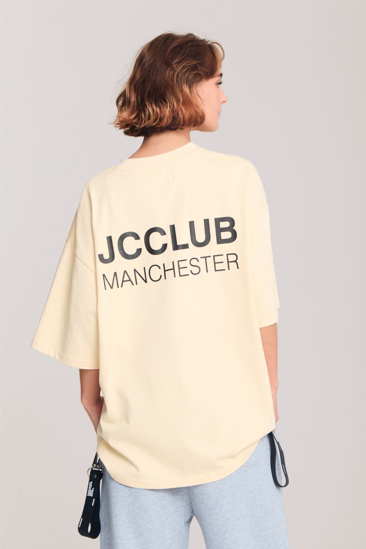 Woman wearing the beige shirt