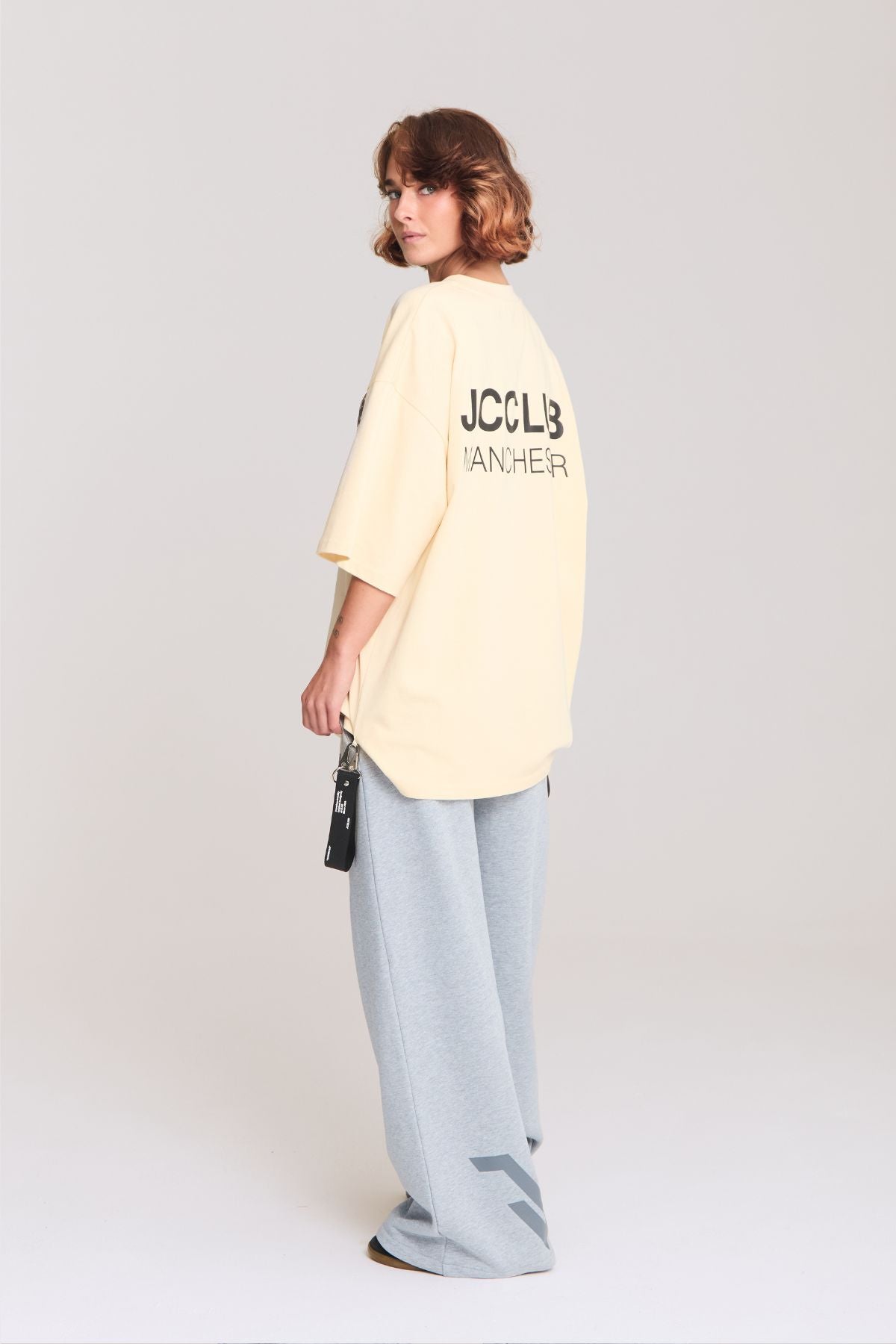 Woman wearing the beige shirt