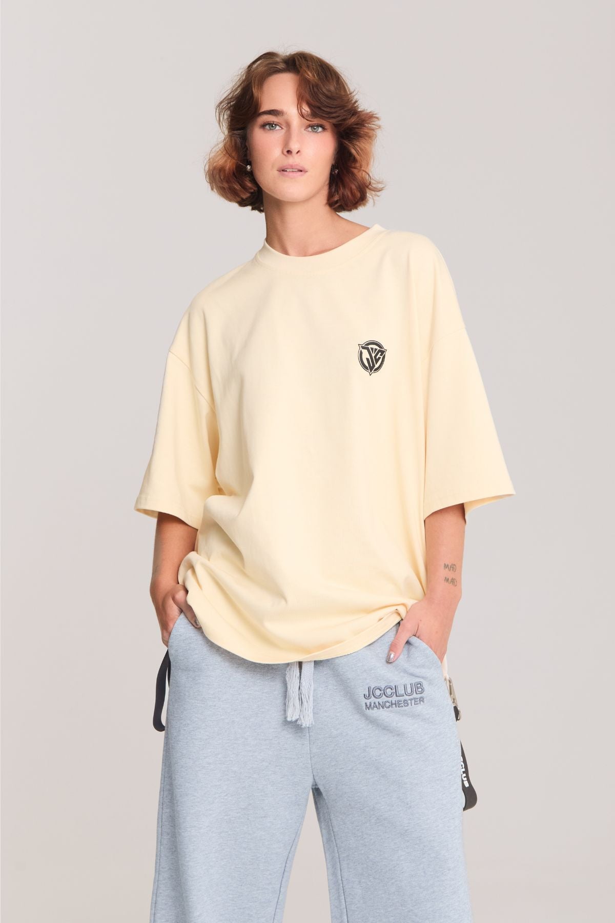 Woman wearing the beige shirt