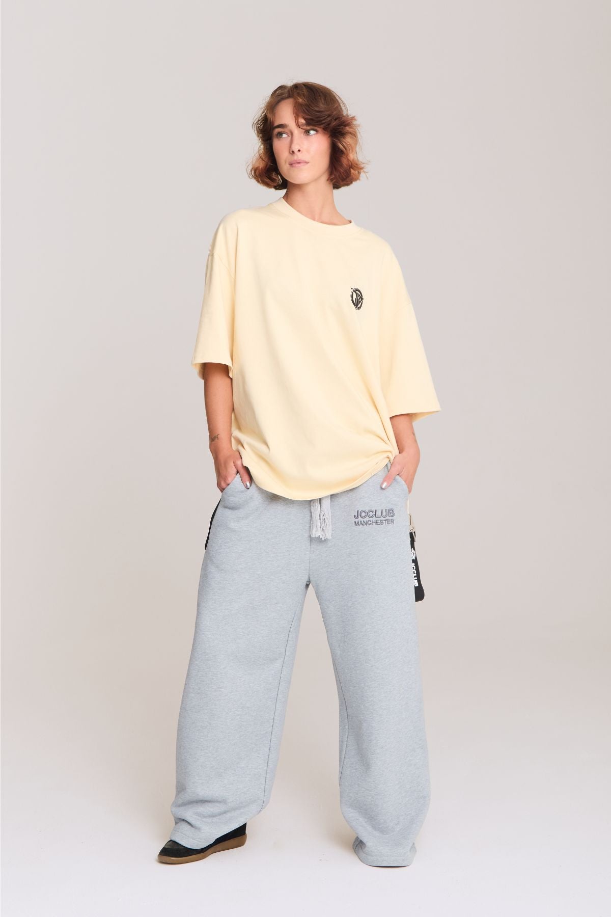 Woman wearing the beige shirt